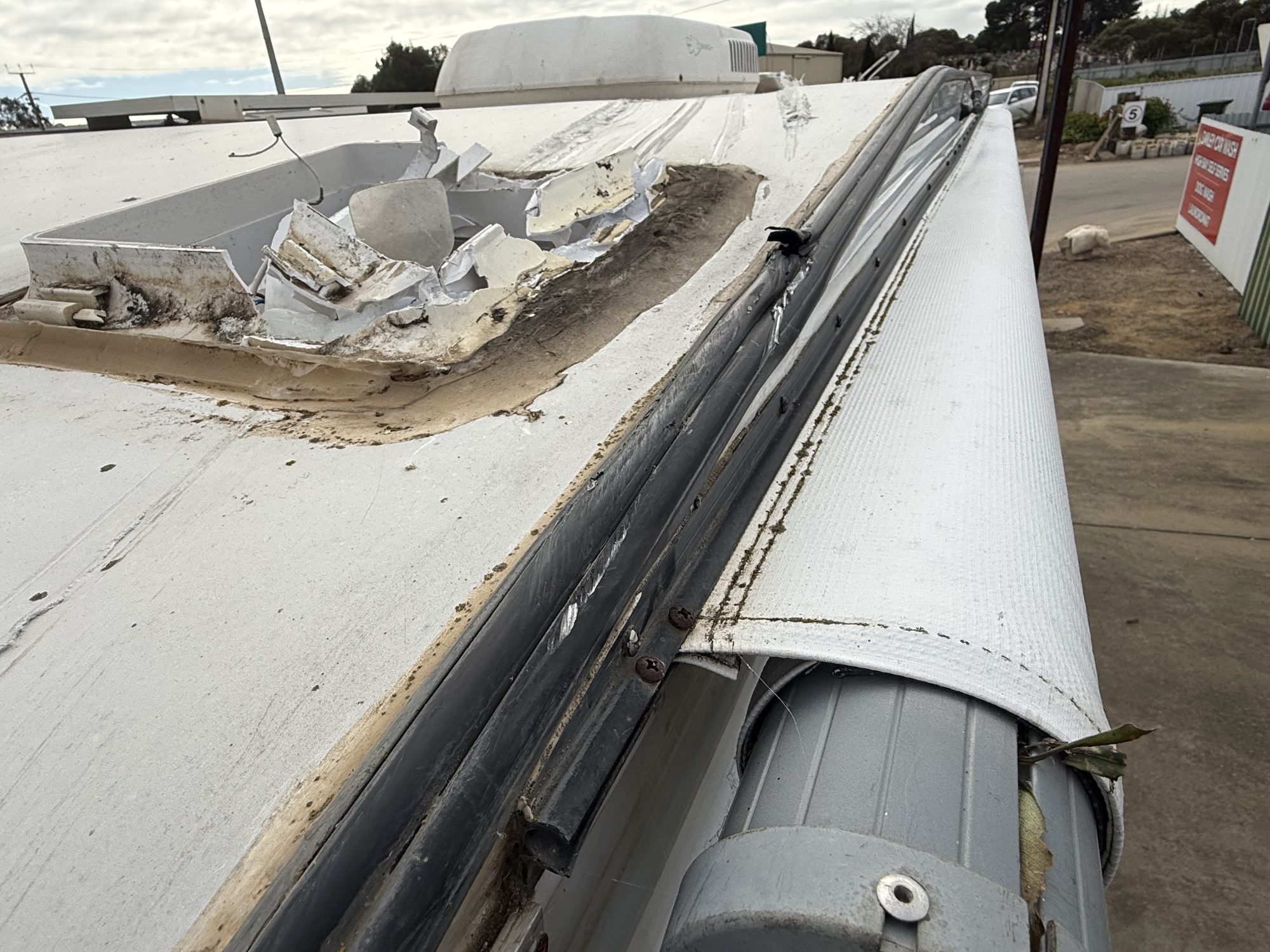 Roof hatch and fibreglass torn on a low-clearance beam