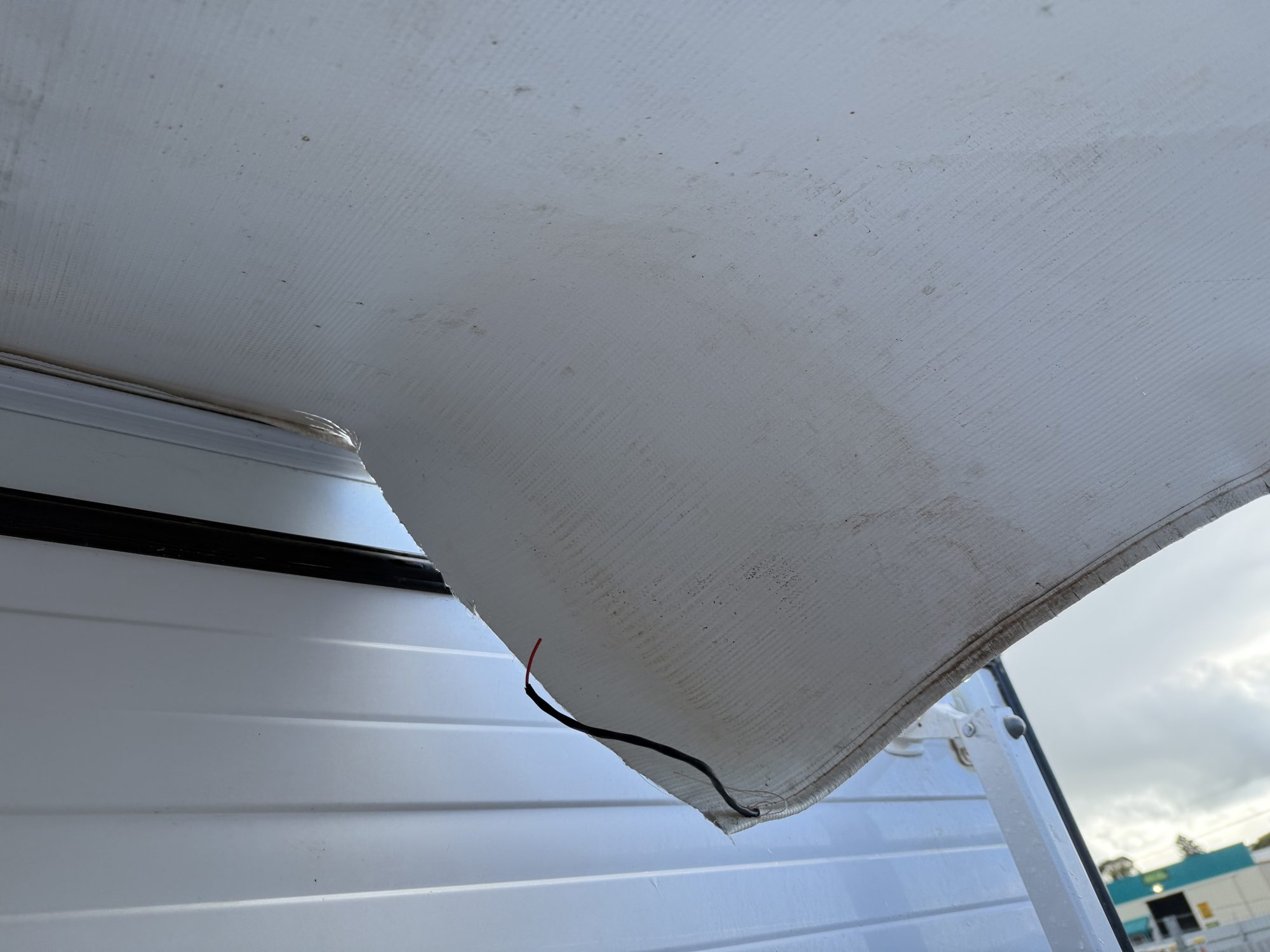 Torn caravan awning awaiting replacement at MBCC